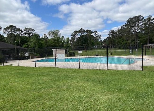 Enjoy the refreshing community pool, perfect for relaxation and socializing in a serene setting. | Image 30