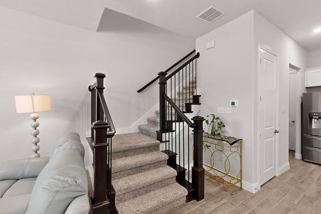 Stairway with baseboards and wood finished floors | Image 7