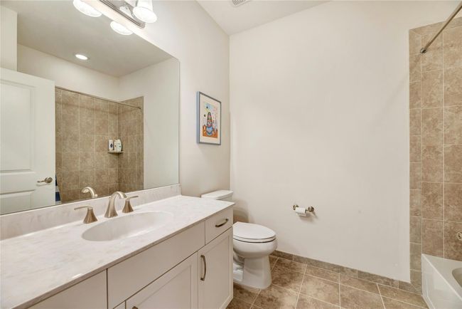 Full bathroom featuring vanity, bathtub / shower combination, and tile patterned floors | Image 14