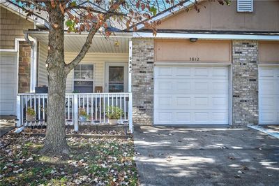 Entrance to property featuring a garage and a porch | Image 2