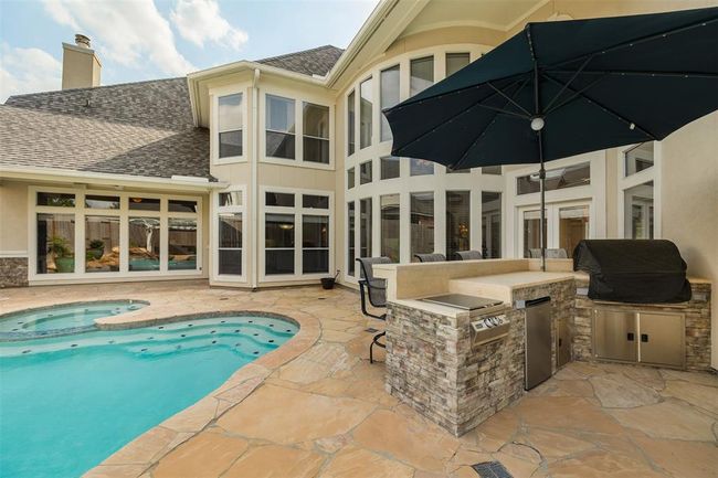 Fire up the grill in the fully equipped outdoor kitchen, updated in 2021, or gather by the fire pit beneath the pergola — this is outdoor living at its finest. | Image 44