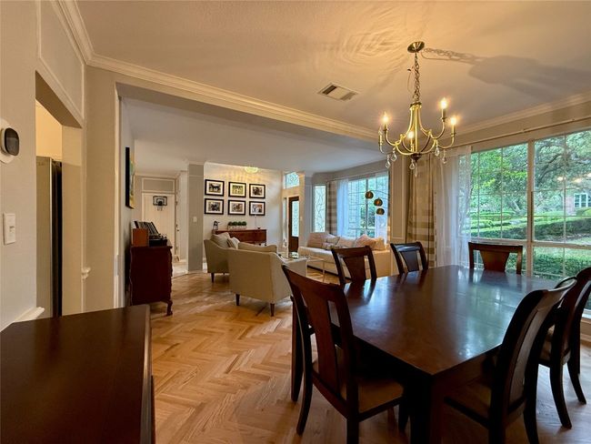 Dining room featuring an inviting chandelier, crown molding, and visible vents | Image 6