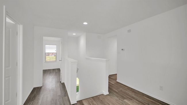 Corridor with recessed lighting, baseboards, wood finished floors, and an upstairs landing | Image 25