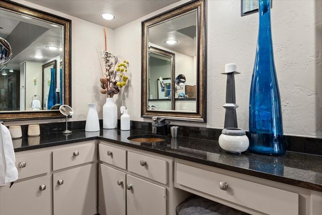 Bathroom featuring copper sinks and a textured wall, custom shower, painted cabinetry. | Image 28