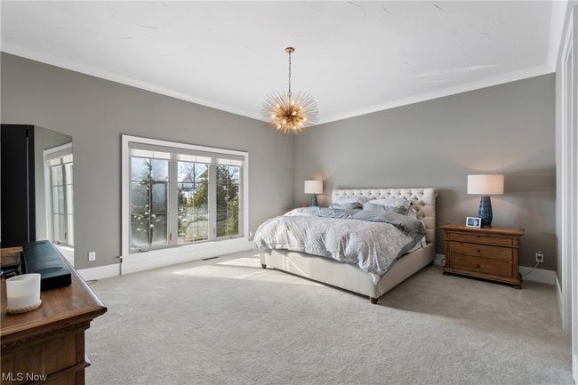 Primary suite featuring an inviting chandelier and ornamental molding | Image 17