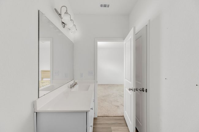A spacious vanity provides plenty of room for daily essentials and grooming. | Image 17