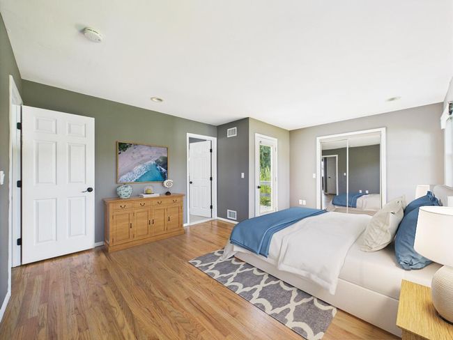 Bedroom featuring wood finished floors and baseboards | Image 20