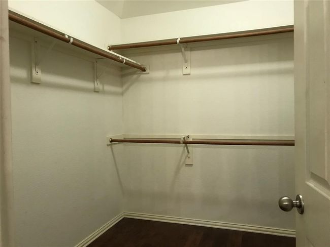 Spacious closet featuring dark wood-style floors | Image 12