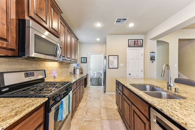 Stainless steel appliances and upgraded finishes give the space a polished, modern feel. | Image 11