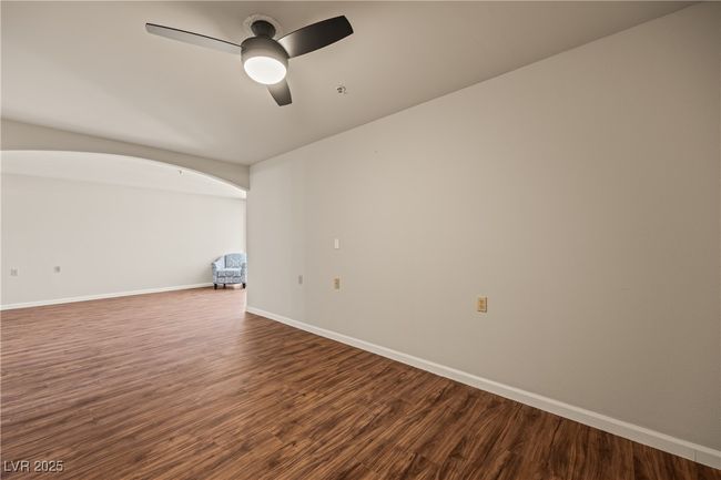 Empty room with a ceiling fan, wood finished floors, and baseboards | Image 16