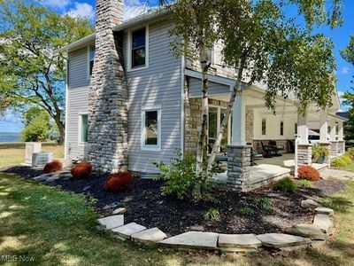 Rear view of property featuring a yard, central AC, and a patio | Image 2