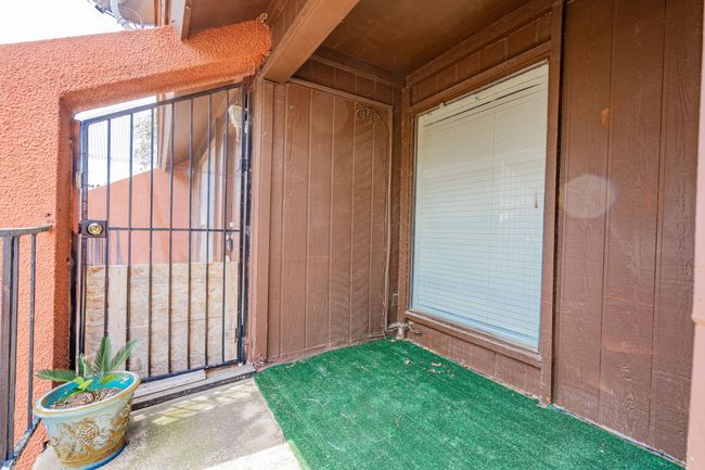 Entrance to property with a gate and board and batten siding | Image 24