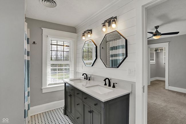 bathroom featuring baseboards, a sink, and a wealth of natural light | Image 30