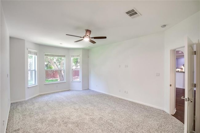 Carpeted empty room with a ceiling fan and baseboards | Image 18