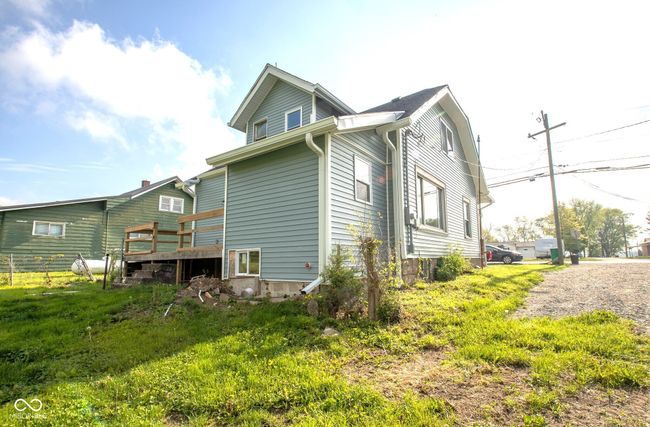 view of property exterior featuring a wooden deck | Image 4