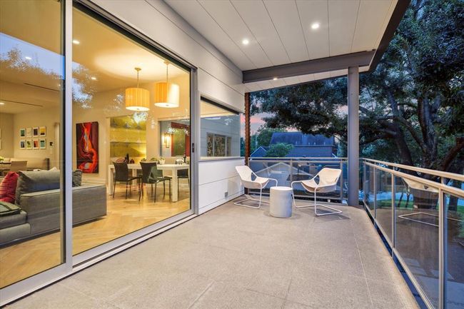 Fleetwood Architectural sliding doors open to one of 2019 Du Barry’s hidden gems—a private 28' x 9' elevated retreat that feels like your own adult treehouse. Surrounded by treetop views, this serene outdoor space is complete with built-in speakers, lighting, and ceiling fans—perfect for relaxing, entertaining, or enjoying quiet moments above it all. | Image 7
