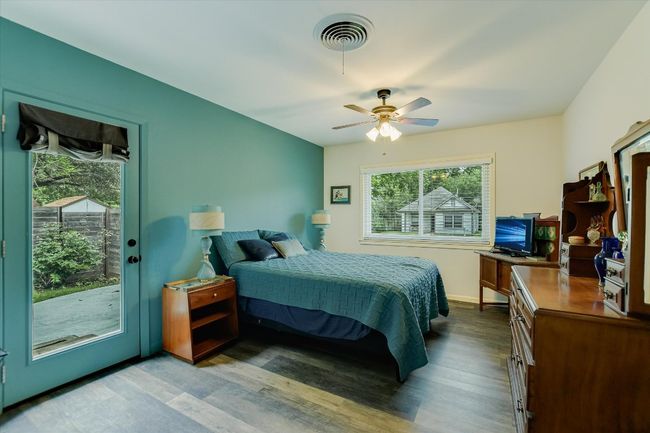 Bedroom with access to outside, wood finished floors, a ceiling fan, and baseboards | Image 12
