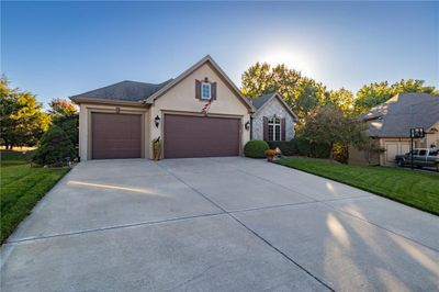 View of front facade with a front yard and a garage | Image 2