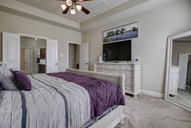 Bedroom with light carpet, ensuite bath, and a ceiling fan | Image 15