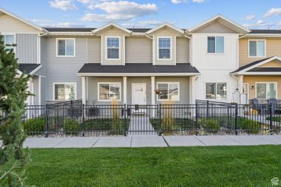 View of property with a front lawn. | Image 1