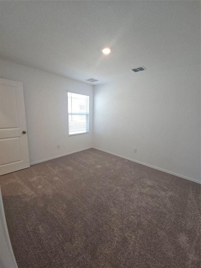 Unfurnished room featuring dark carpet and baseboards | Image 12