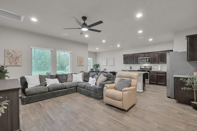 The open-concept floor plan creates a seamless flow between the living, dining, and kitchen area—perfect for staying connected. | Image 7