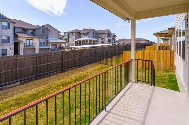 Wooden deck with a residential view and a fenced backyard | Image 26