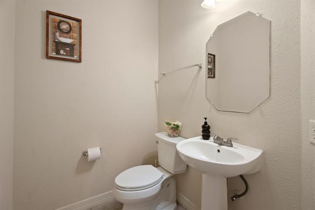 Adjacent to the utility room, a half bath rounds out the downstairs, and is great for guests. | Image 14
