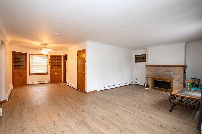 Living room with newer plank flooring | Image 5