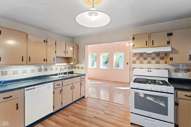 Kitchen with view into second Family Room | Image 31