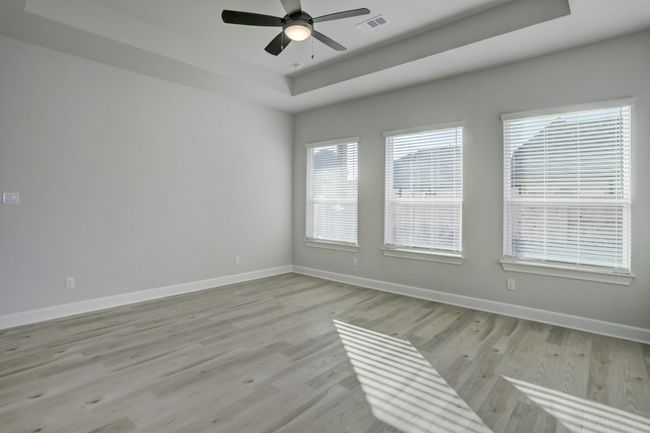The owner’s suite in the Saurel plan offers you a spacious retreat to enjoy rest and relaxation. A spacious master bedroom with large windows creates a dreamy way to begin and end each day. | Image 5