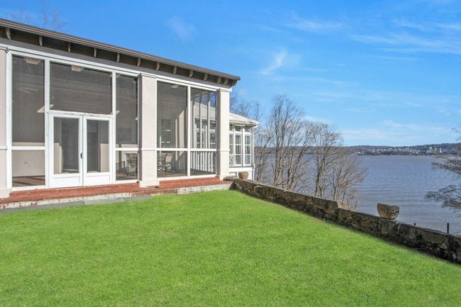 View of yard with a sunroom and a water view | Image 5