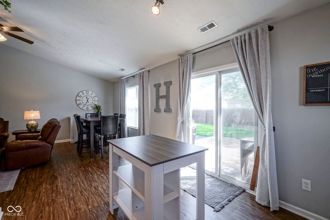 dining room featuring visible vents, ceiling fan, dark wood-style floors, and baseboards | Image 17