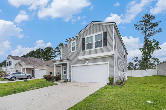 Traditional-style house featuring driveway and a garage | Image 6