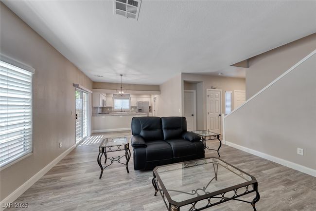 Living area with baseboards and light wood-style floors | Image 5