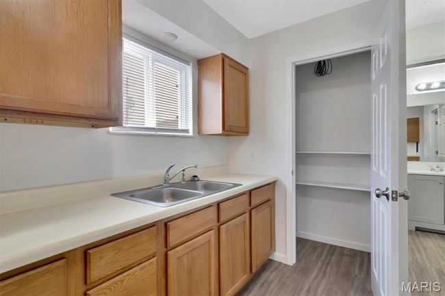 Kitchen with LVP floors, sink, and pantry | Image 9