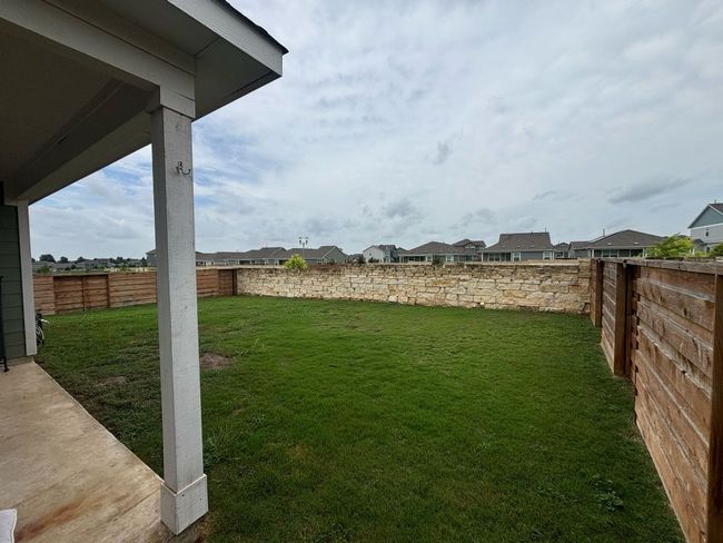 Fenced backyard with a residential view | Image 7