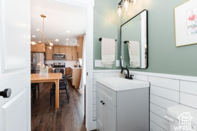 Bathroom featuring vanity, wood finished floors, a wainscoted wall, and toilet | Image 28
