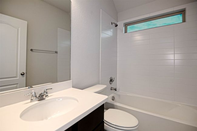 Bathroom featuring toilet, vanity, and shower / bathtub combination | Image 33