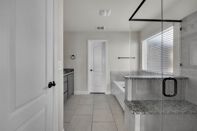Ensuite with tile patterned floors, vanity, and shower with separate bathtub | Image 23