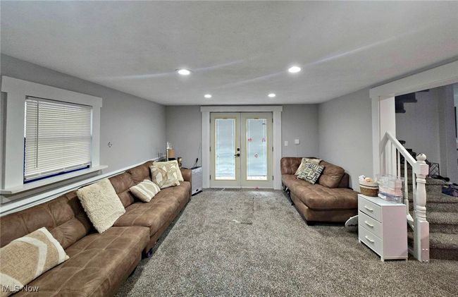 Carpeted living area featuring stairway, recessed lighting, and french doors | Image 28
