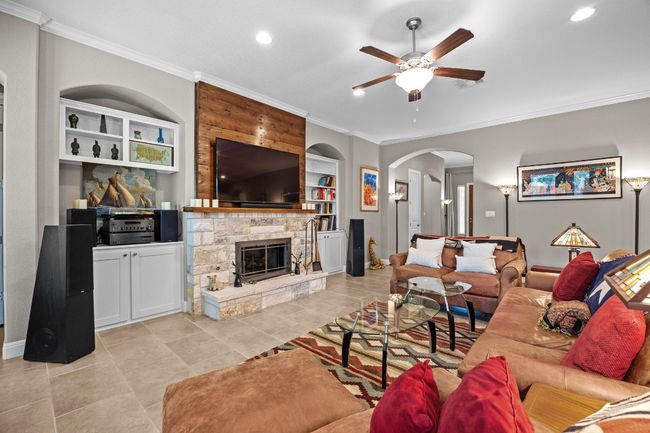 The stone fireplace steals the show, with built-in bookshelves that turn the living room into the perfect blend of warmth and character | Image 11