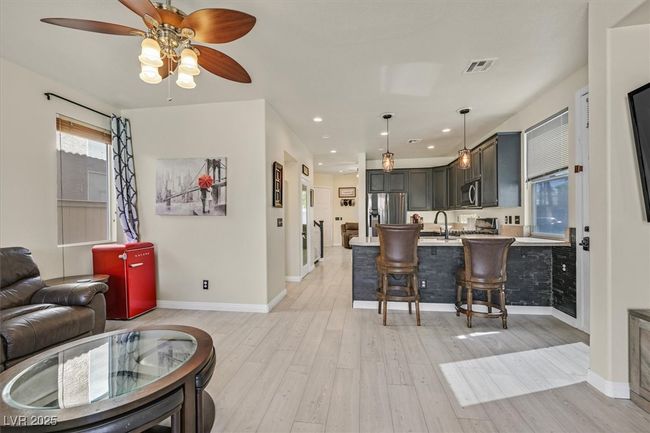 Living room featuring baseboards, visible vents, recessed lighting, ceiling fan, and light wood-type flooring | Image 7