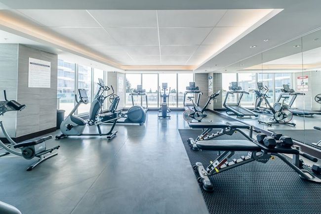 Exercise room with expansive windows and a raised ceiling | Image 29