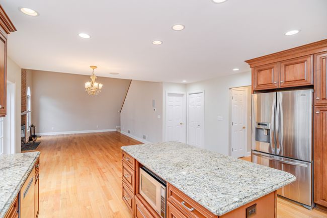 Granite counters and in-island microwave. | Image 9