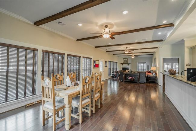 You will notice that the bar can seat many stools for your guests, and a pool table can easily fit between the living and dining areas. | Image 18