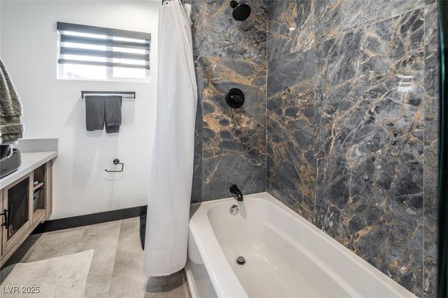 Full bathroom featuring vanity, shower / bathtub combination with curtain, and baseboards | Image 26