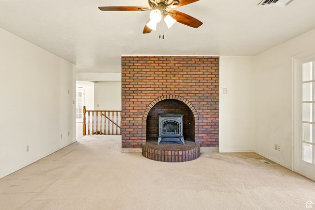 Unfurnished living room with carpet and a ceiling fan | Image 10