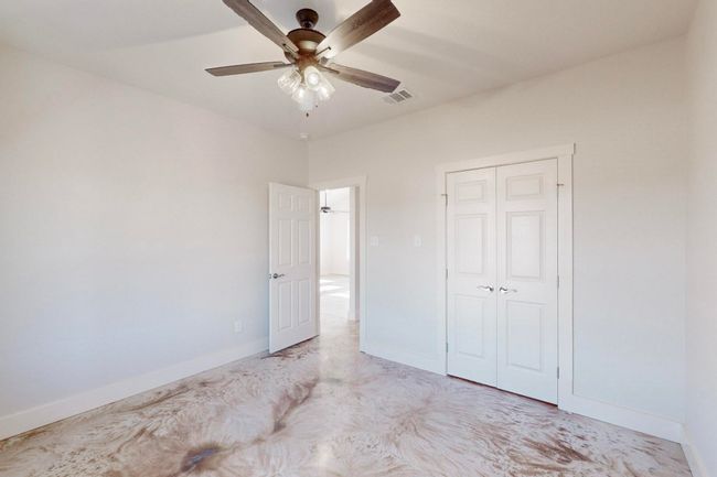 Unfurnished bedroom featuring visible vents, a closet, baseboards, and a ceiling fan | Image 31