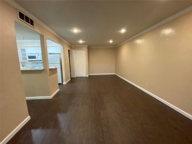 Unfurnished room featuring recessed lighting, dark wood-type flooring, baseboards, visible vents, and crown molding | Image 6